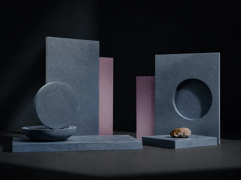 Repeated blue-gray mineral planes with mauve inserts, circular cutouts, bowls, and stones on black.