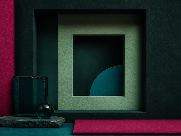 Nested square niches and dark glass in pomegranate purple, pale green, blue green, and deep slate green.