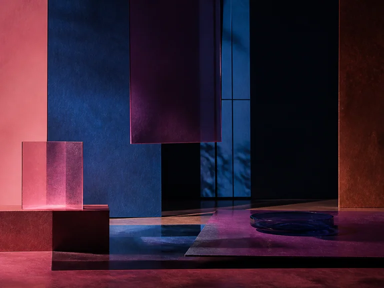 Layered smoked glass and paper screens in pink, russet, deep blue, and dark violet.