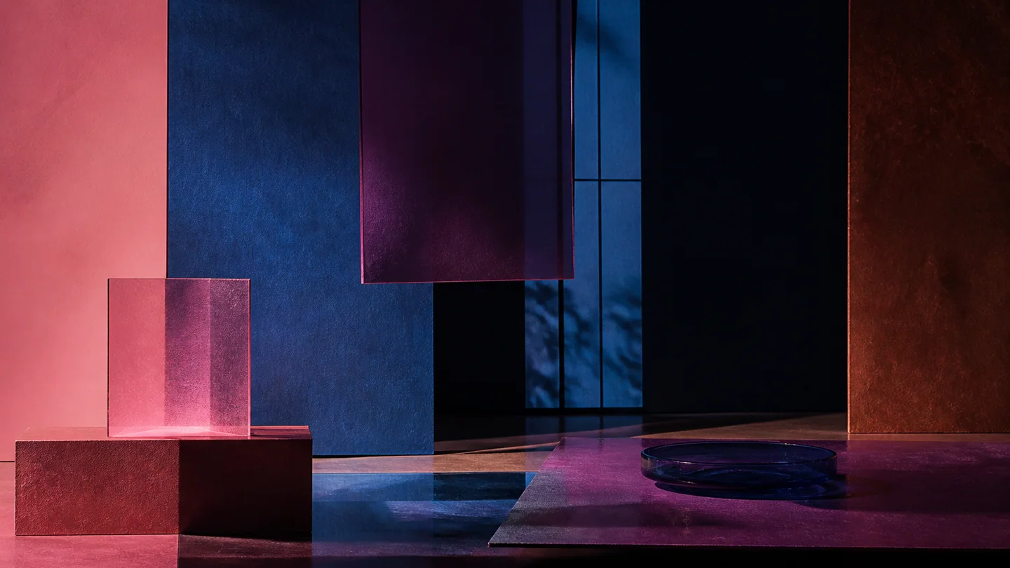 Layered smoked glass and paper screens in pink, russet, deep blue, and dark violet.